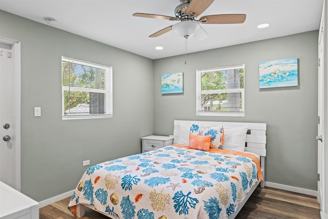 bedroom with ceiling fan and dark hardwood / wood-style flooring