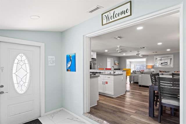 entryway featuring ceiling fan and sink