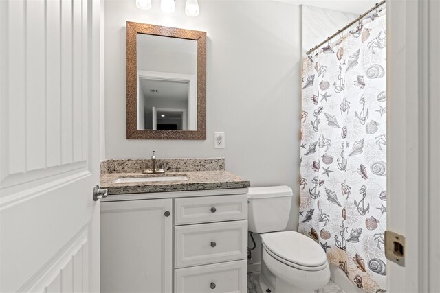 bathroom with vanity, toilet, and a shower with shower curtain