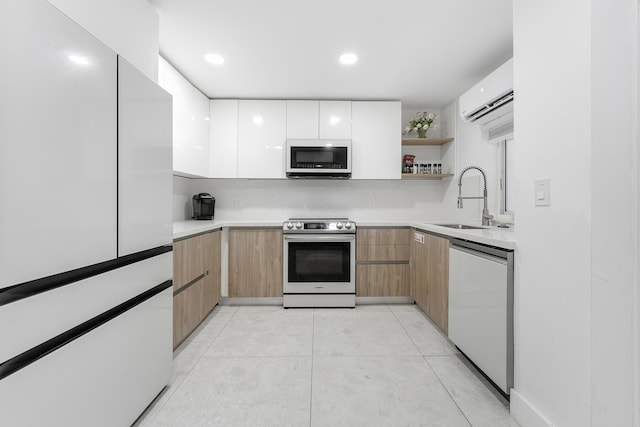 kitchen featuring light tile patterned flooring, sink, a wall mounted AC, appliances with stainless steel finishes, and white cabinets