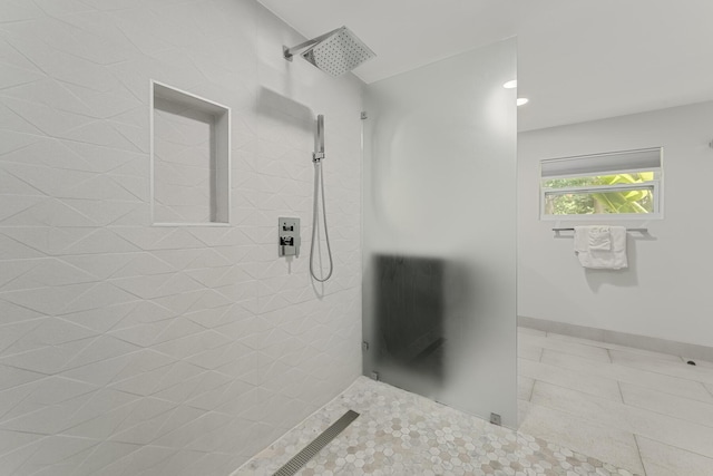 bathroom with tiled shower and tile patterned floors