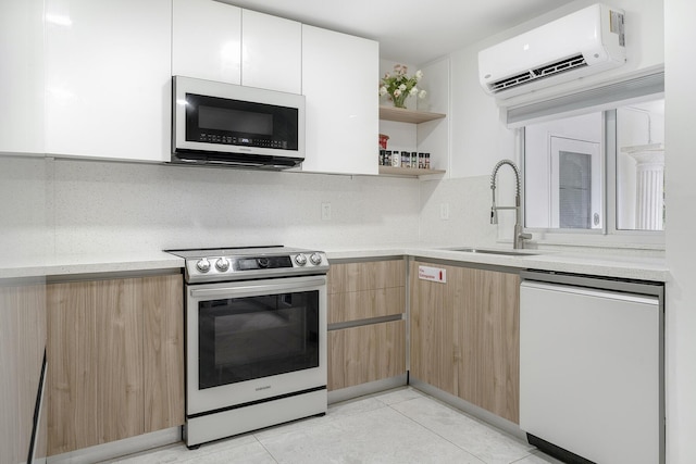 kitchen with dishwashing machine, sink, electric range, a wall mounted AC, and white cabinets