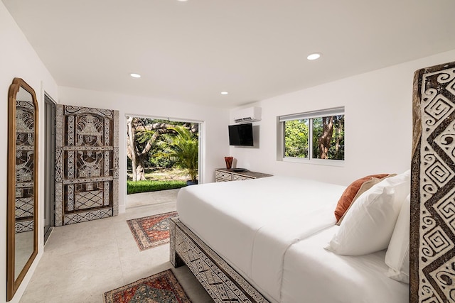 bedroom featuring a wall mounted air conditioner and access to outside