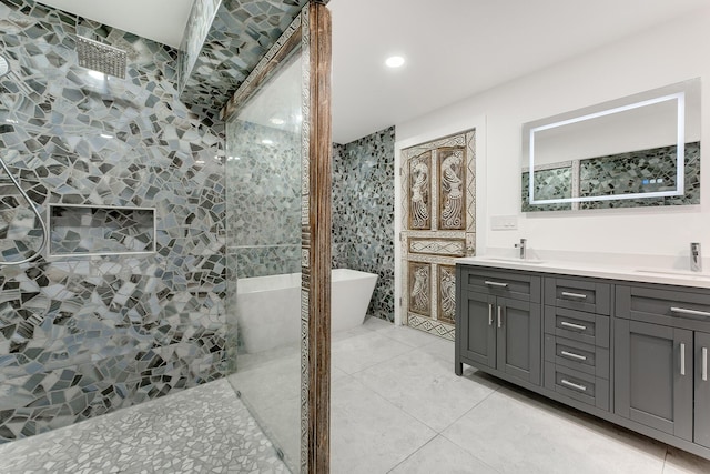 bathroom featuring tile patterned floors, vanity, and a tile shower