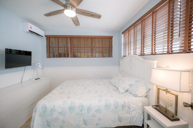 bedroom featuring ceiling fan and a wall mounted air conditioner