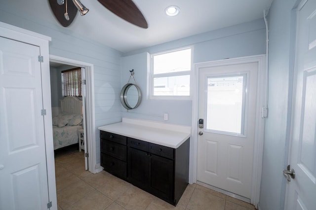 doorway to outside featuring light tile patterned floors and ceiling fan