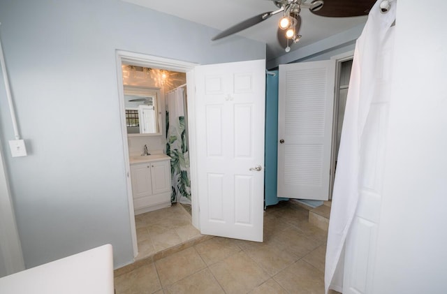 interior space featuring ceiling fan, ensuite bathroom, and sink