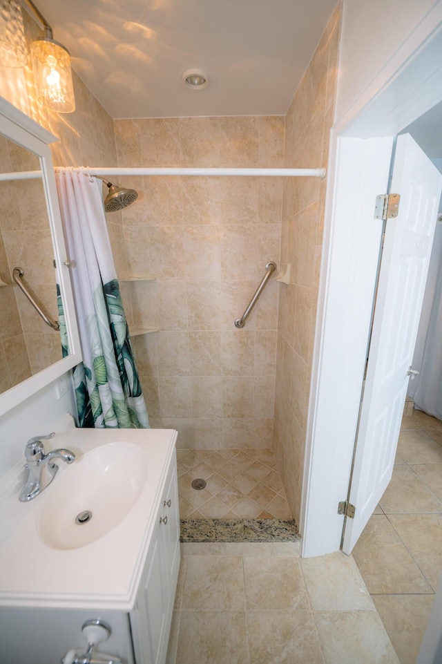 bathroom featuring vanity, curtained shower, and tile patterned floors