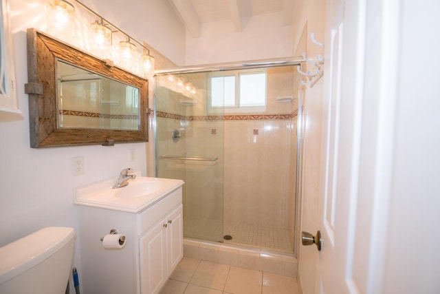 bathroom featuring tile patterned floors, toilet, a shower with door, and vanity