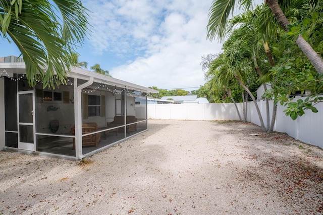 view of yard with a sunroom and a patio area