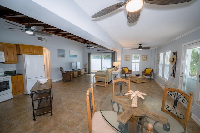 tiled dining area featuring ornamental molding and beamed ceiling