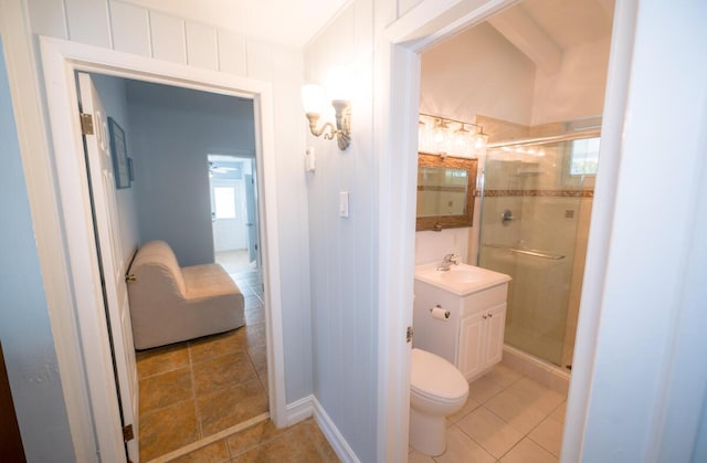 bathroom with vanity, tile patterned floors, a shower with door, and toilet