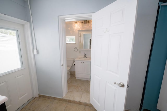 bathroom with tile patterned floors, vanity, and toilet