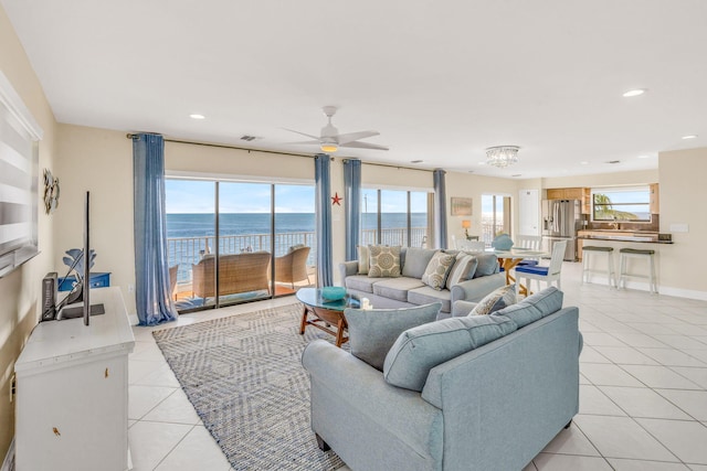 33 Kyle Way, Marathon, FL 33050 - living area with a water view, light tile patterned floors, recessed lighting, ceiling fan, and a chandelier