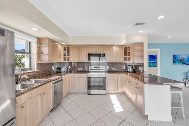 33 Kyle Way, Marathon, FL 33050 - kitchen featuring stainless steel appliances, open shelves, a peninsula, a kitchen bar, and tasteful backsplash