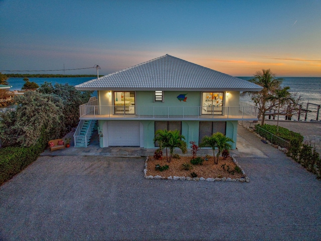 33 Kyle Way, Marathon, FL 33050 - view of front of property with stairs, a water view, gravel driveway, and stucco siding