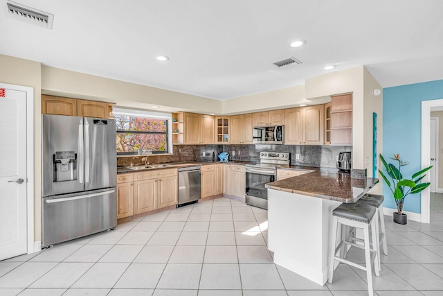 33 Kyle Way, Marathon, FL 33050 - kitchen with stainless steel appliances, open shelves, a peninsula, tasteful backsplash, and light tile patterned flooring