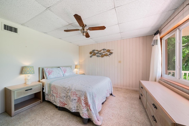 bedroom with a drop ceiling and ceiling fan