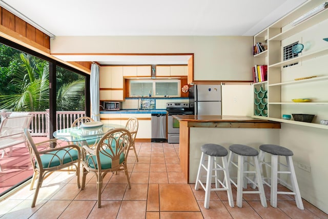 kitchen featuring stainless steel appliances and light tile patterned floors