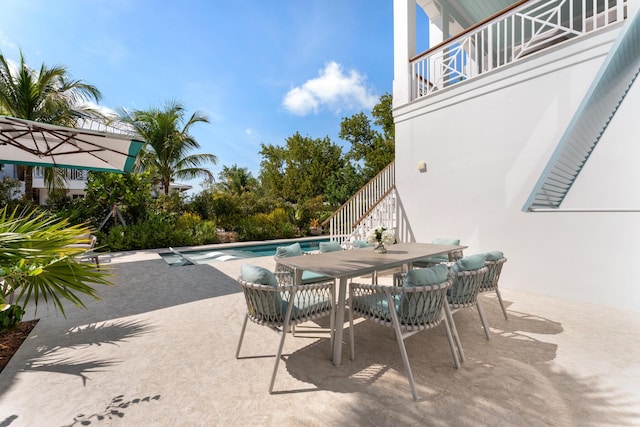 76180 Overseas Hwy, Islamorada, FL 33036 - view of patio / terrace featuring an outdoor pool, outdoor dining area, and a balcony