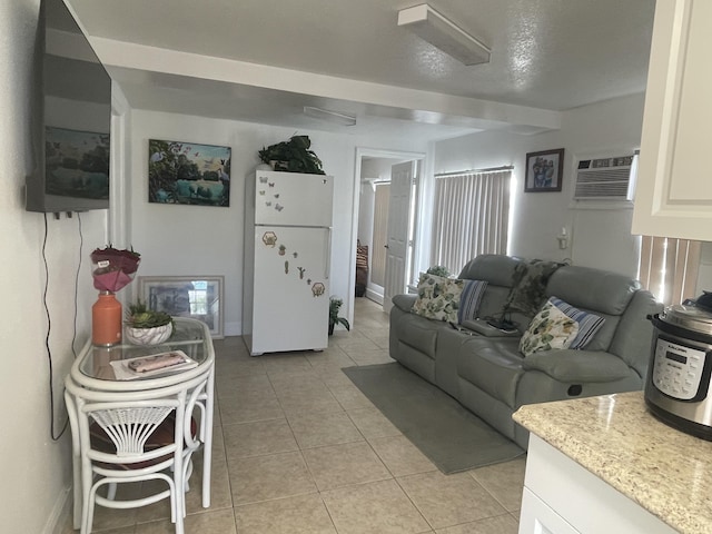 living room featuring light tile patterned floors, baseboards, and a wall unit AC