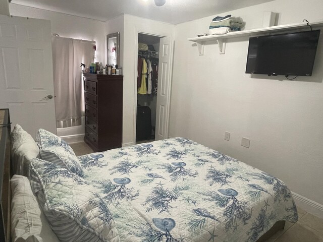 bedroom with a walk in closet and a closet