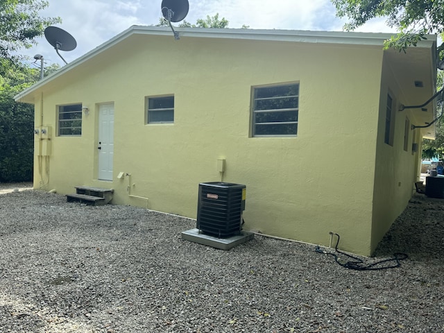 220 W Indies Rd, Tavernier, FL 33070 - rear view of house with entry steps and stucco siding