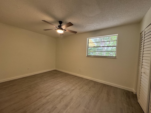 220 W Indies Rd, Tavernier, FL 33070 - unfurnished bedroom featuring dark wood-type flooring, a textured ceiling, and ceiling fan