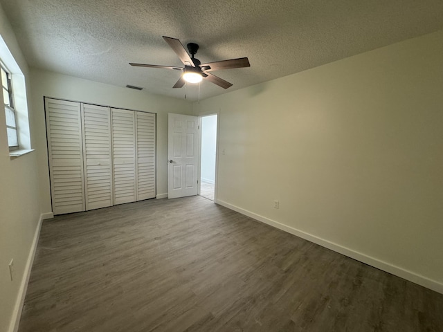 220 W Indies Rd, Tavernier, FL 33070 - unfurnished bedroom featuring dark wood-style flooring, a closet, a textured ceiling, and a ceiling fan