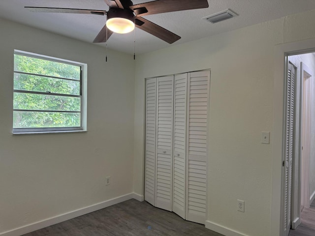 220 W Indies Rd, Tavernier, FL 33070 - unfurnished bedroom featuring dark wood-style flooring, a closet, and a ceiling fan