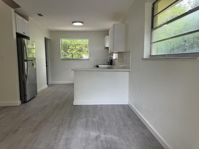 220 W Indies Rd, Tavernier, FL 33070 - kitchen with freestanding refrigerator, dark wood finished floors, light countertops, and white cabinets