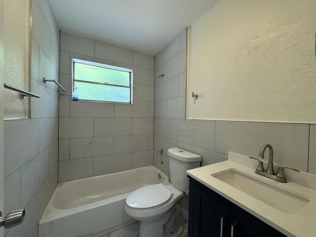 220 W Indies Rd, Tavernier, FL 33070 - bathroom featuring tile walls, vanity, bathtub / shower combination, and a textured wall
