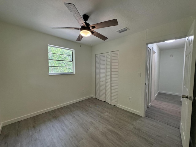 220 W Indies Rd, Tavernier, FL 33070 - unfurnished bedroom with wood finished floors, a closet, a ceiling fan, and a textured ceiling