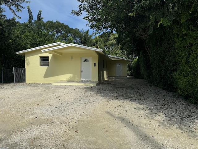220 W Indies Rd, Tavernier, FL 33070 - view of front of home with stucco siding and driveway