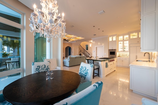 dining room featuring sink and a chandelier