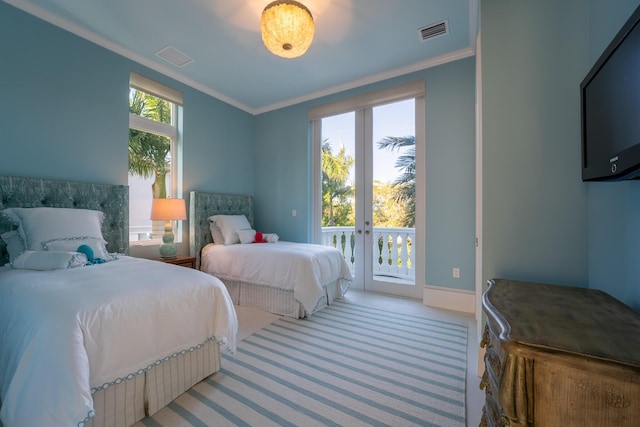 carpeted bedroom featuring crown molding, access to outside, and french doors