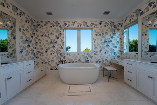 bathroom with ornamental molding, a bathing tub, and vanity