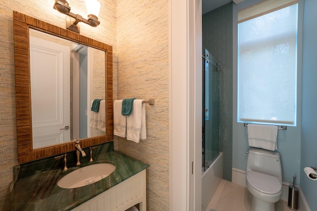 full bathroom featuring vanity, toilet, and combined bath / shower with glass door