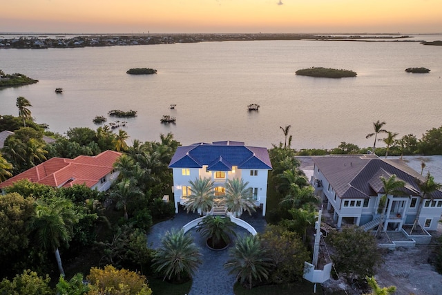 aerial view at dusk with a water view