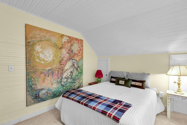 carpeted bedroom with vaulted ceiling