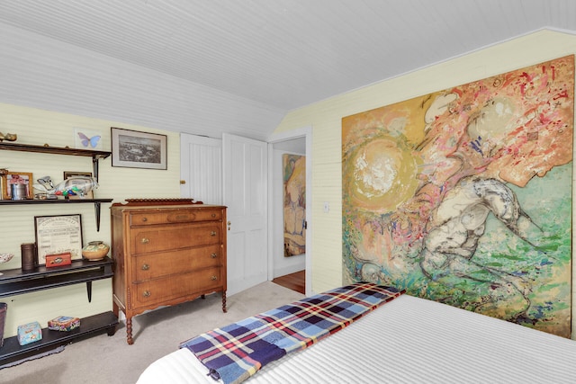 carpeted bedroom with lofted ceiling