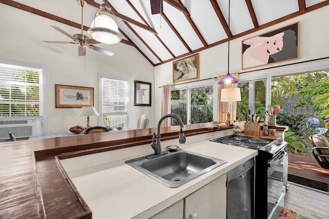 kitchen featuring high vaulted ceiling, sink, hanging light fixtures, black appliances, and light wood-type flooring