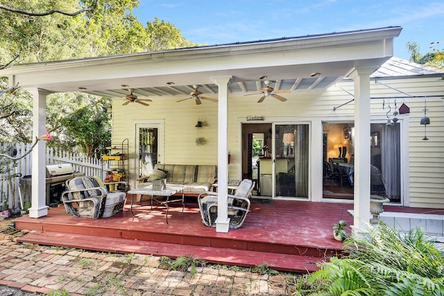 deck featuring area for grilling and ceiling fan