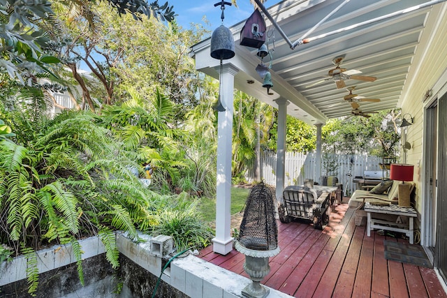 wooden deck featuring outdoor lounge area and ceiling fan