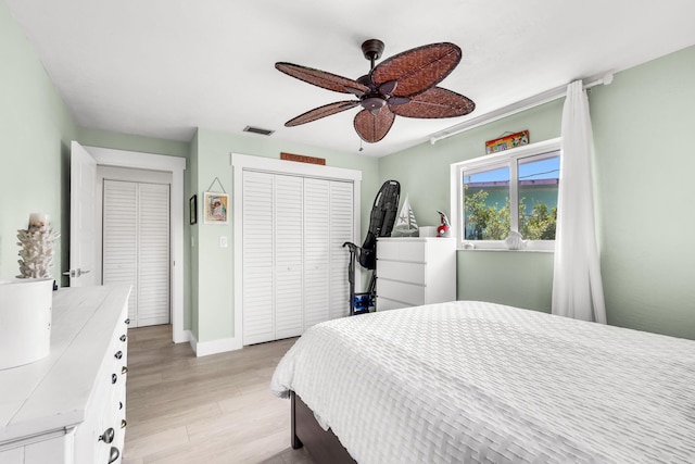 bedroom featuring ceiling fan, a closet, and light wood-type flooring