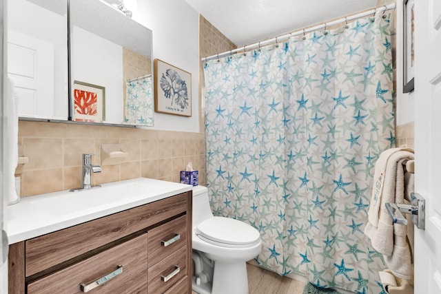 bathroom with tile walls, vanity, hardwood / wood-style floors, and toilet