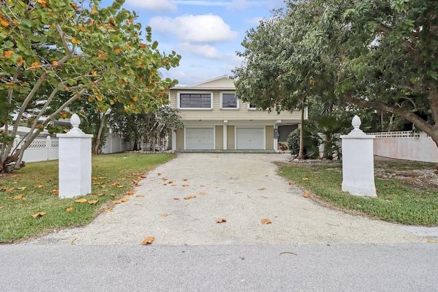 view of front of home featuring fence, driveway, and an attached garage