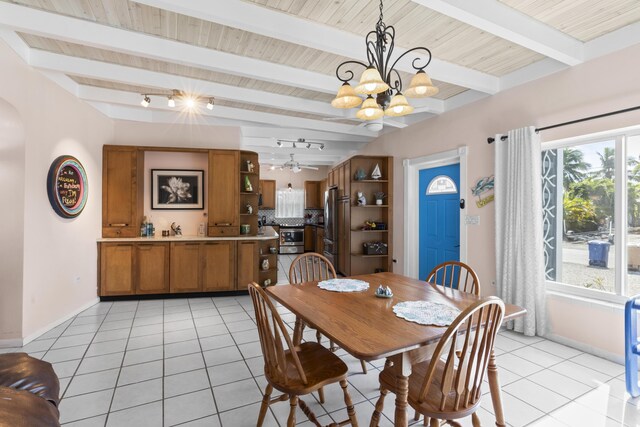 dining room featuring a wealth of natural light, ceiling fan with notable chandelier, beam ceiling, and light tile patterned floors