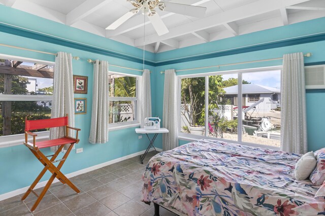 bedroom with ceiling fan, tile patterned floors, and beam ceiling