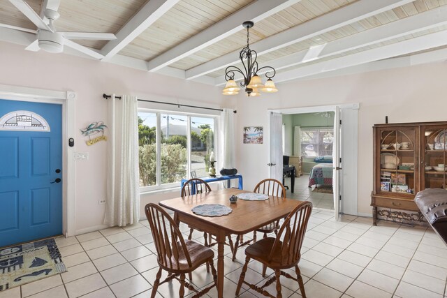 dining room with ceiling fan with notable chandelier, light tile patterned floors, wooden ceiling, and beam ceiling